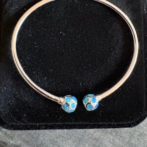 .925 sterling silver bangle bracelet with 8 mm balls at the end.